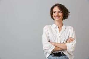 Image of happy young business woman posing isolated over grey wall background.